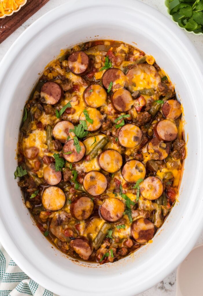 Overhead hero pic of the baked cowboy casserole inside the slow cooker. 