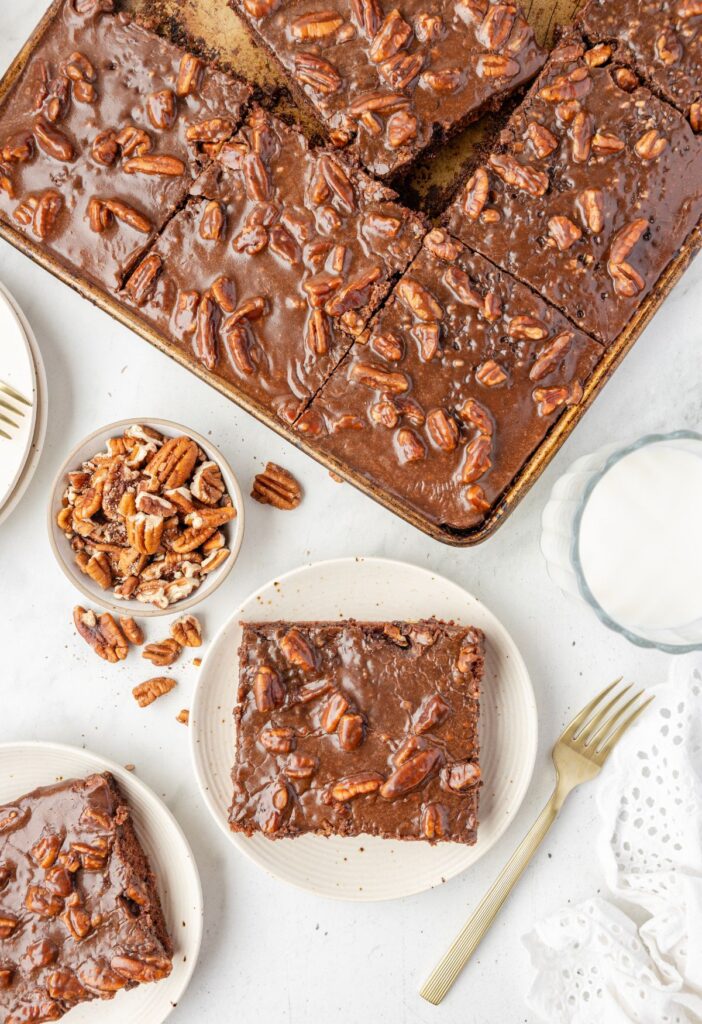 Overhead pic of the Texas sheet cake with a serving plate of a slice. 