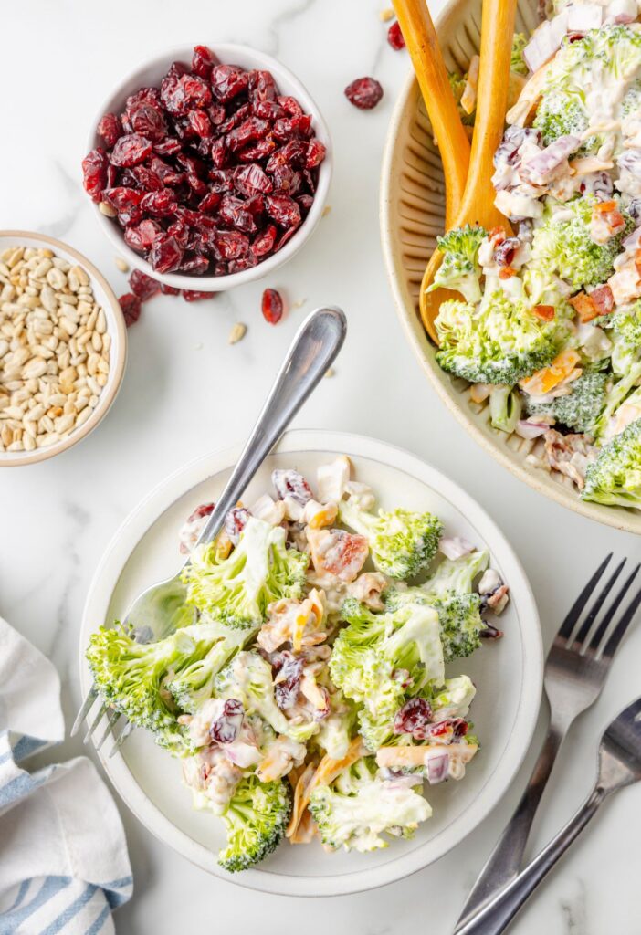 Top view of the salad bowl and a serving plate with a portion on it. 