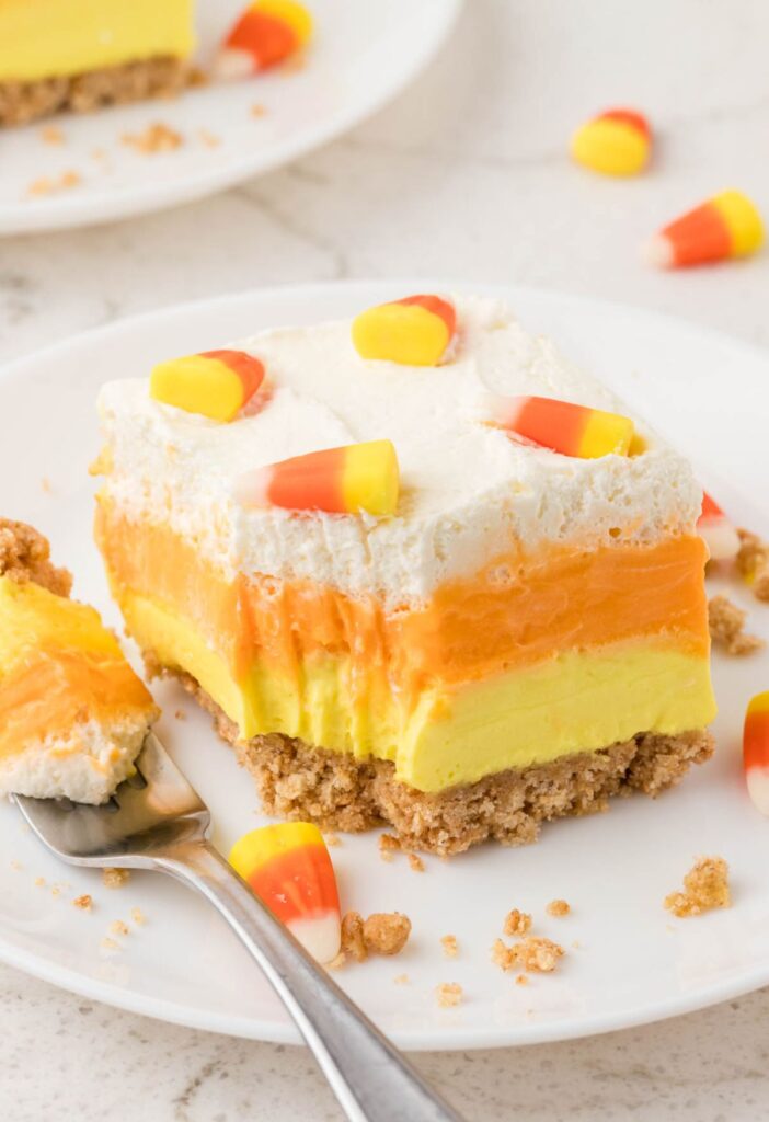 Slice of lush dessert with a fork bite taken out of the front of it