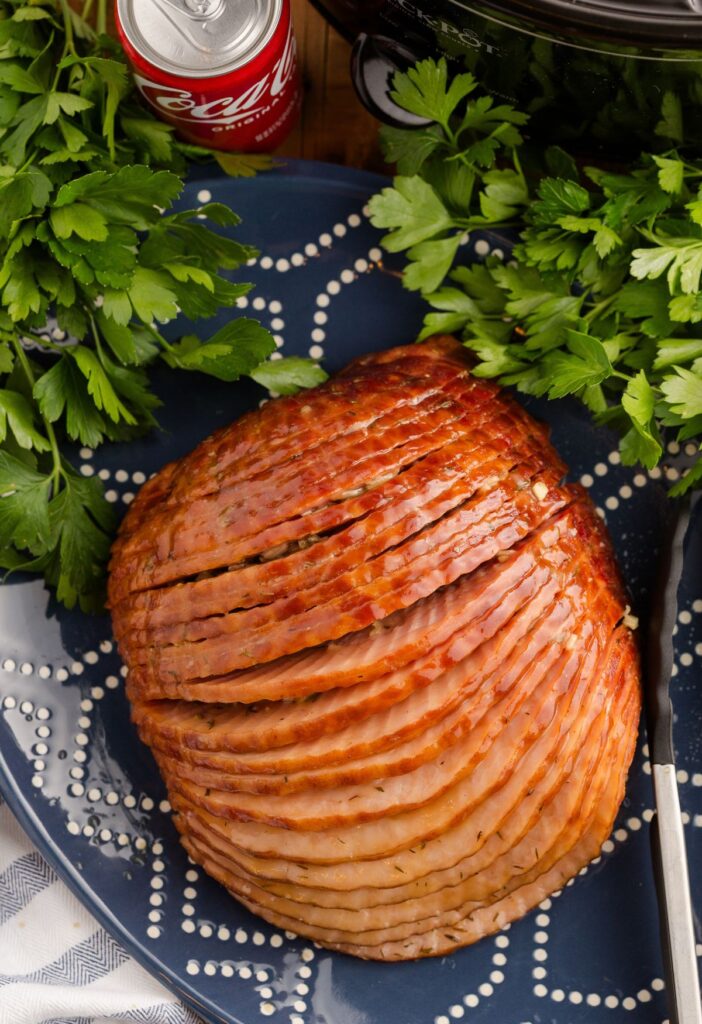 Spiral cut ham on a blue serving platter