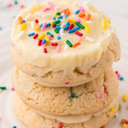 A stack of frosted funfetti cookies