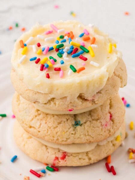 A stack of frosted funfetti cookies