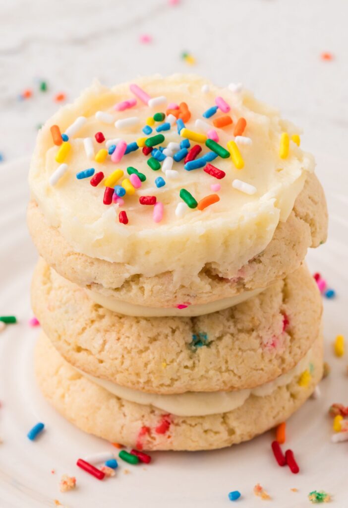 A stack of frosted funfetti cookies