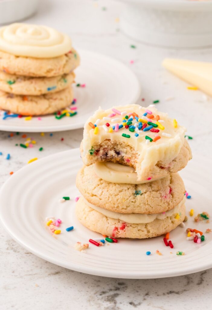 Stack of cookies with the top one having a bite taken out of it. 