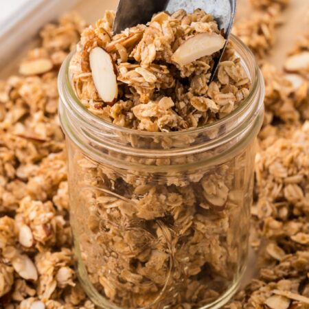 A jar of granola with a scoop