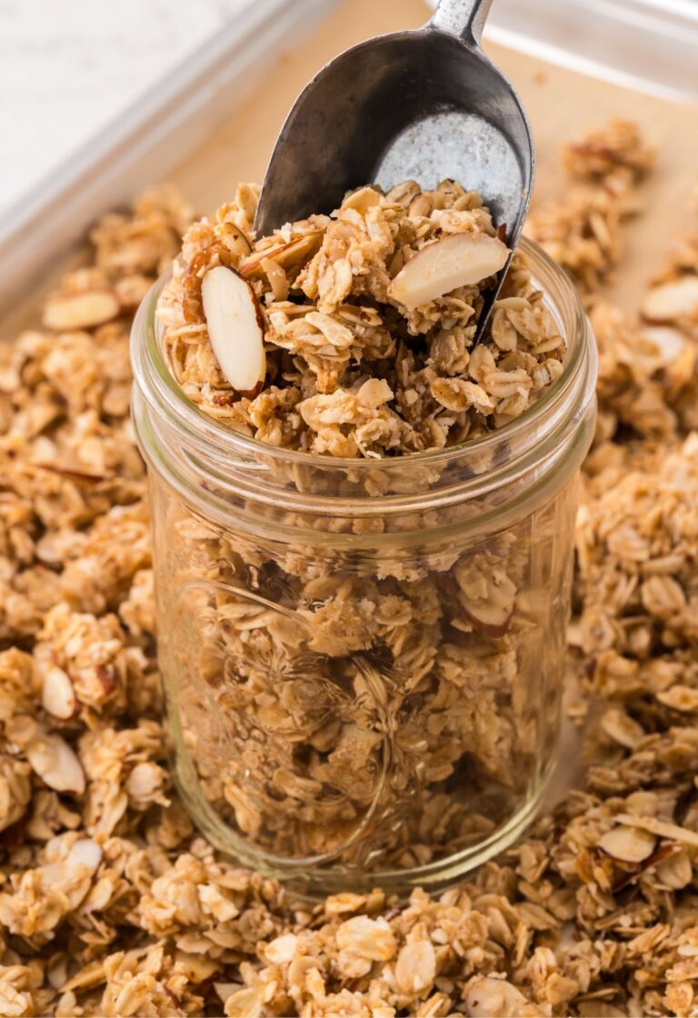 A jar of granola with a scoop
