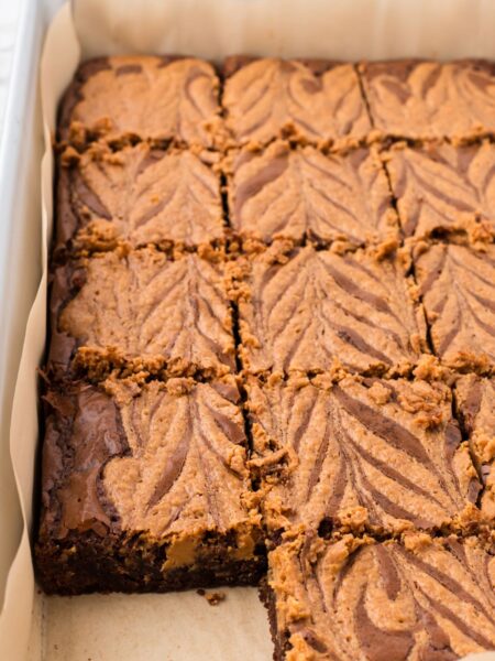 side view of the pan of baked brownies with a peanut butter swirl on top.