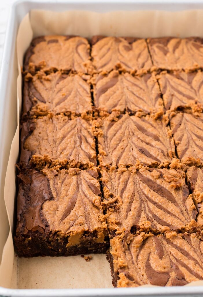 side view of the pan of baked brownies with a peanut butter swirl on top. 