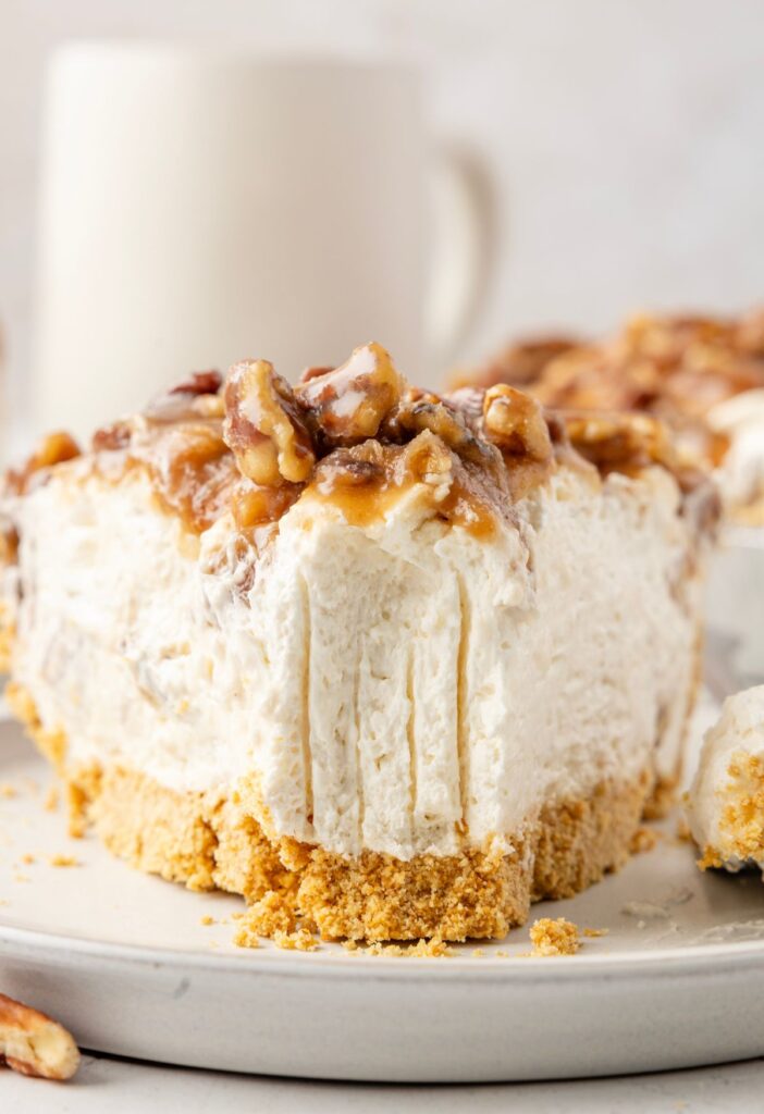Front view of a slice of pie with a fork bite taken out of it.