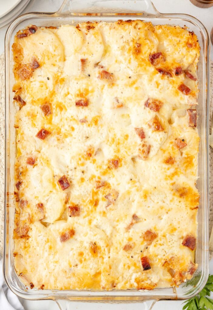 Top view of the baked scalloped potatoes inside the glass casserole dish. 