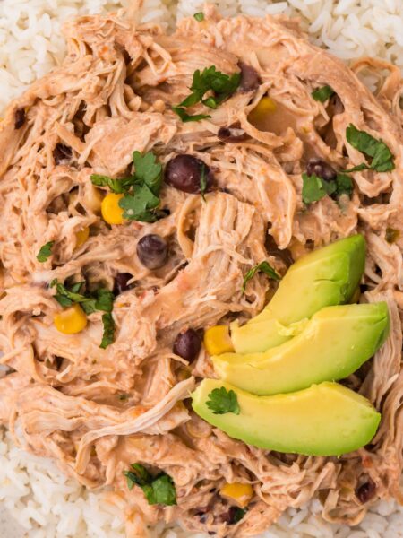 A serving of fiesta chicken with avocado slices on top