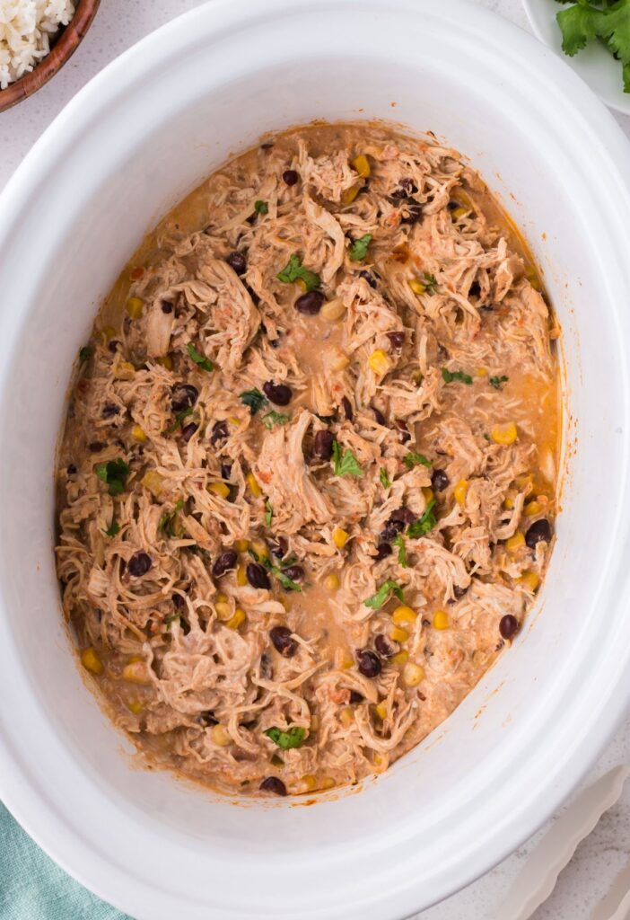 Inside of the slow cooker with the shredded creamy chicken
