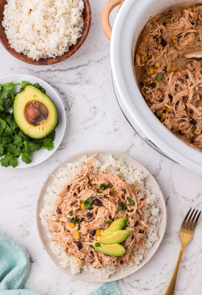 Slow cooker and a plate with the fiesta chicken on it