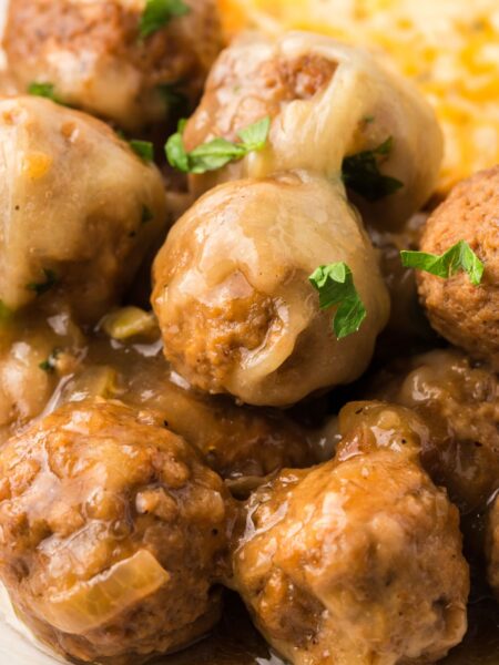 Close up of the meatballs with gruyere cheese
