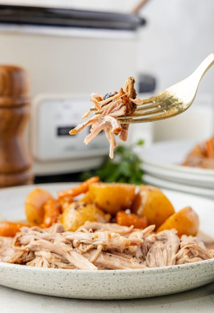 A fork with some pork roast on it