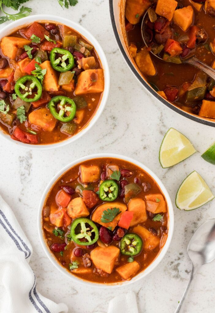 Serving bowl of chili with the soup pot of chili