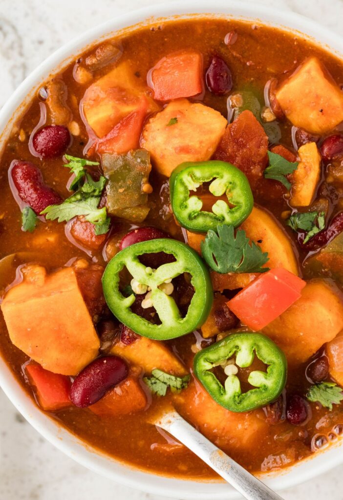 A serving of sweet potato chili in a white bowl