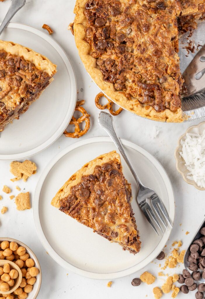 Slice of pie on a serving plate and the pie plate of the baked Texas trash pie next to it.