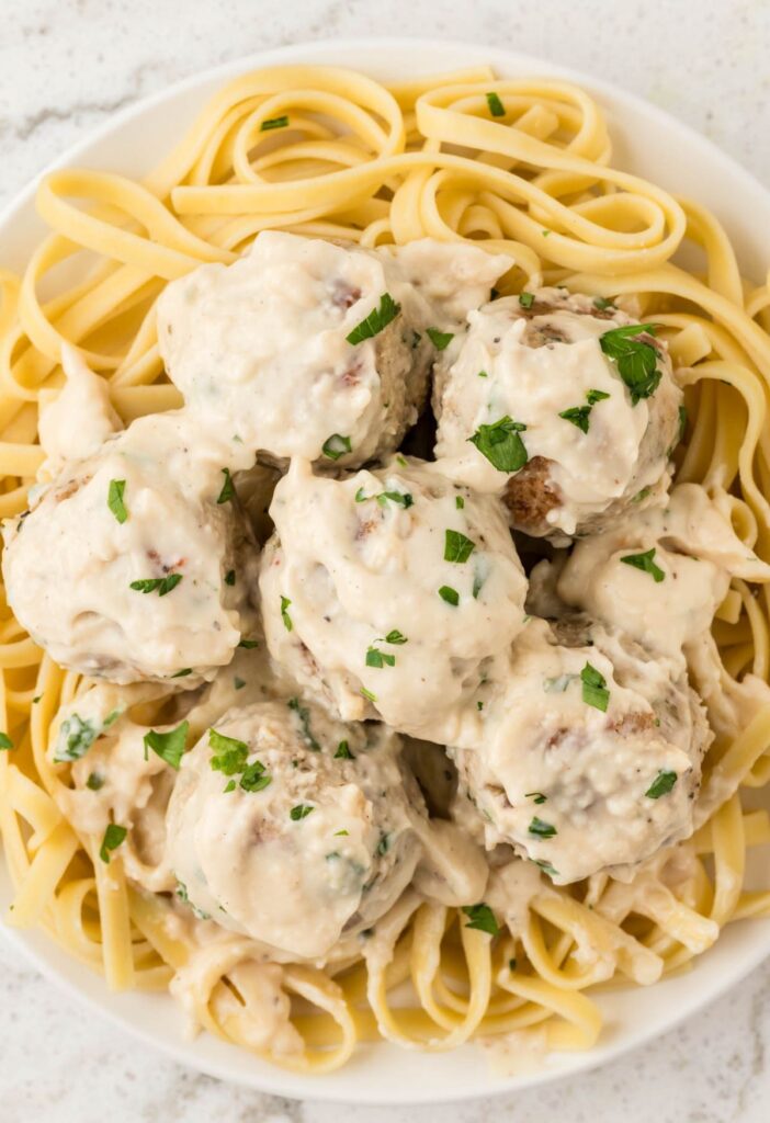 Plate of pasta with meatballs and Alfredo sauce