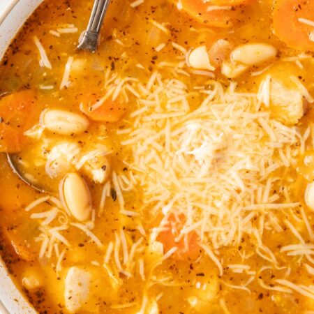 Top view of the soup inside a white bowl with a spoon in it.