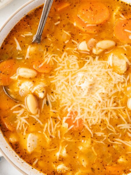 Top view of the soup inside a white bowl with a spoon in it.