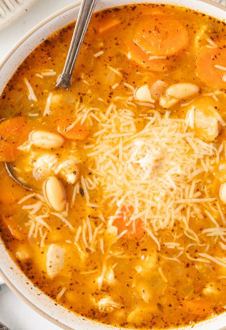 Top view of the soup inside a white bowl with a spoon in it.