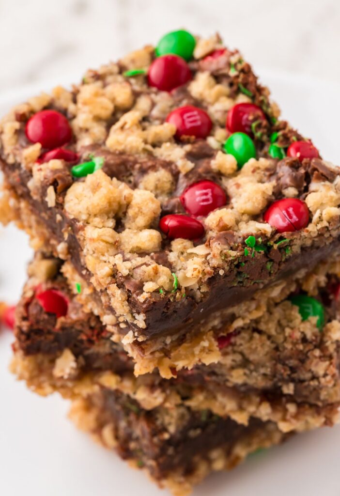 Stack of christmas cookie bars with red and green candies. 