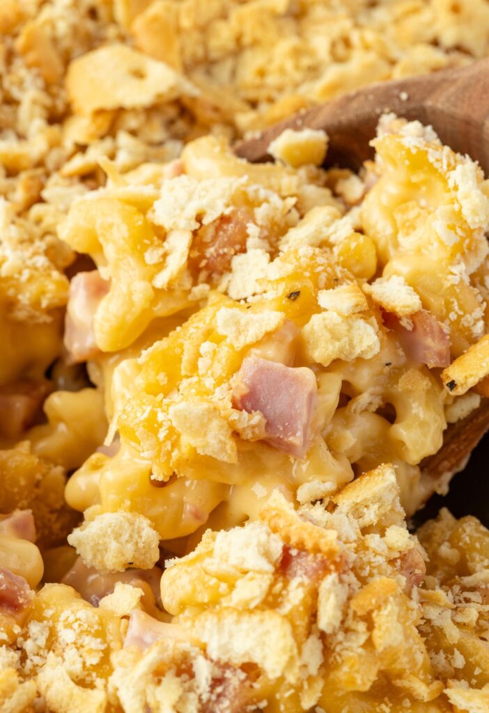 Wooden spoon with some casserole on it