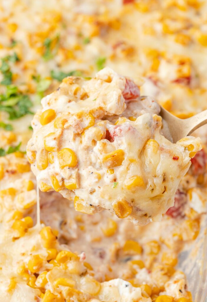 A spoon of the cheesy hot corn dip