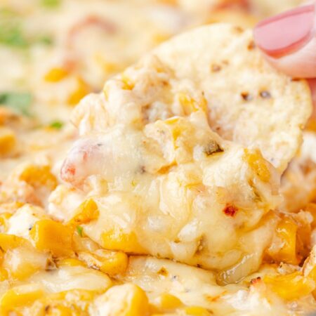 A chip being dipped into the corn dip