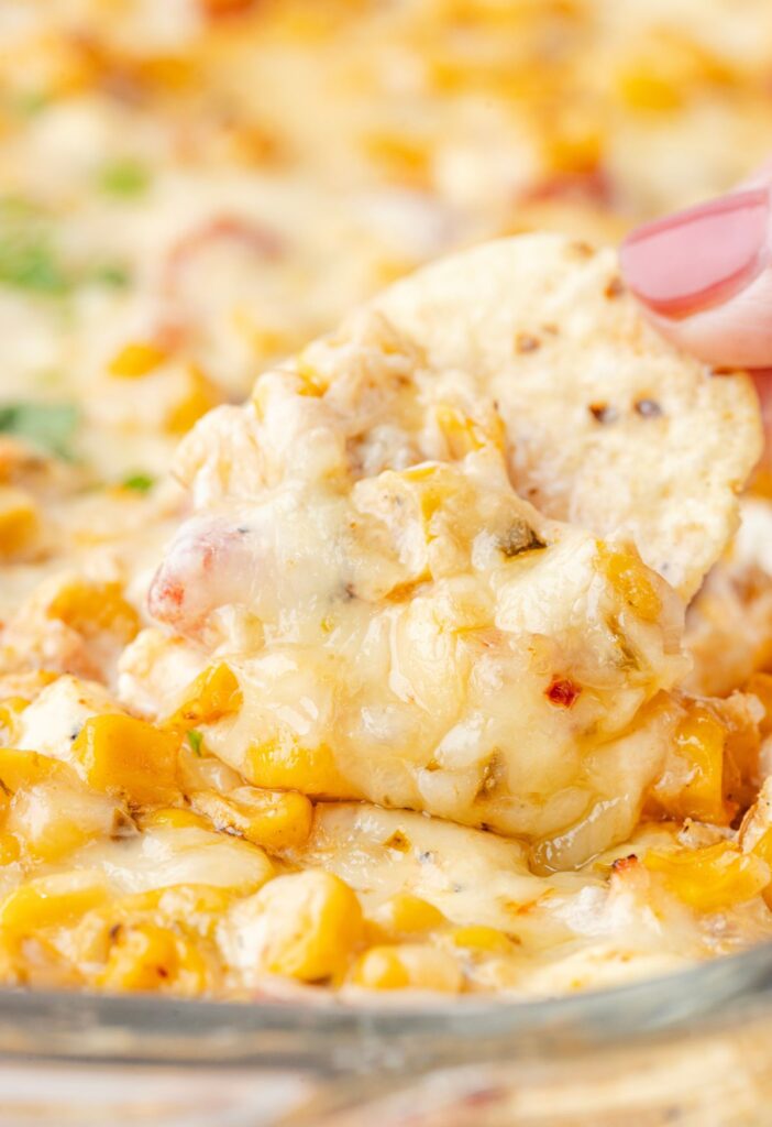 A chip being dipped into the corn dip