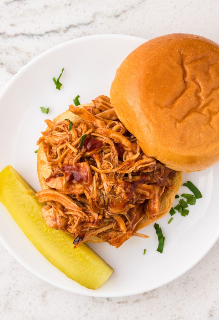 Open faced sandwich with the shredded bbq chicken on it. 