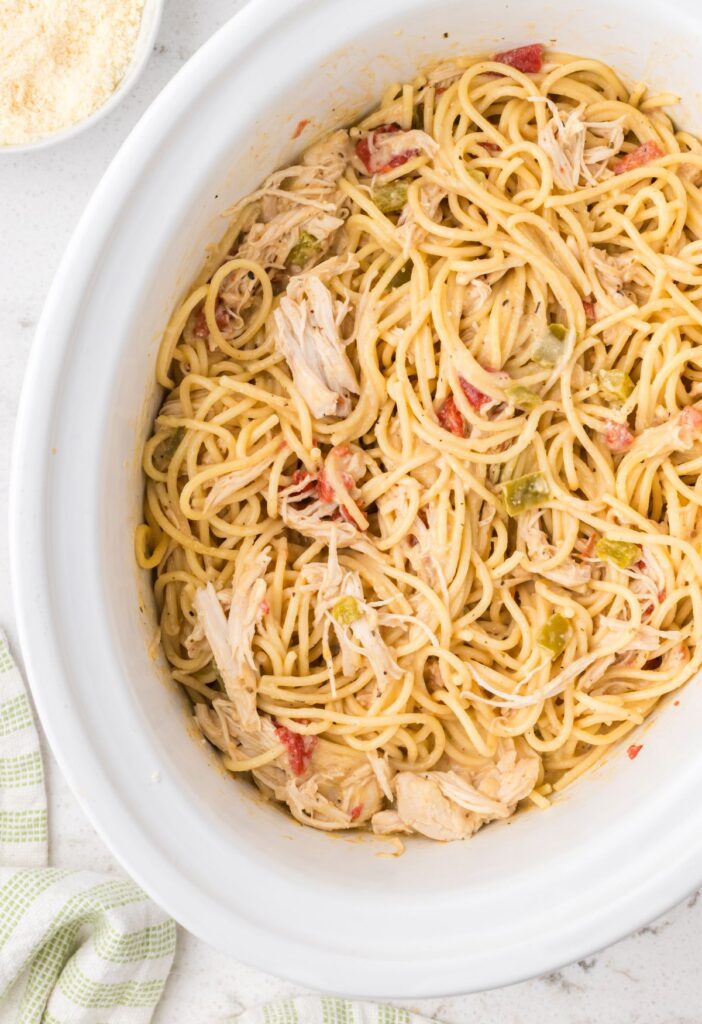 Slow cooker with the spaghetti inside of it.