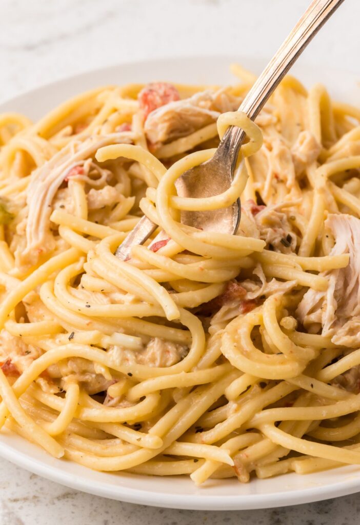 hero shot of the cheesy creamy chicken spaghetti made in the crock pot.