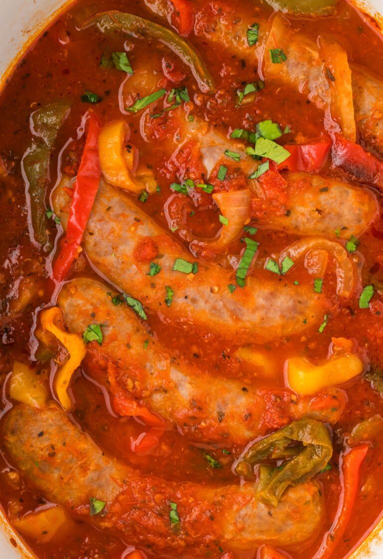 Top close up view of the sausages and peppers in marinara sauce.