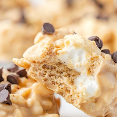 Two cookies with a bite taken out of one so you can see the marshmallows