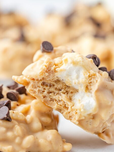 Two cookies with a bite taken out of one so you can see the marshmallows