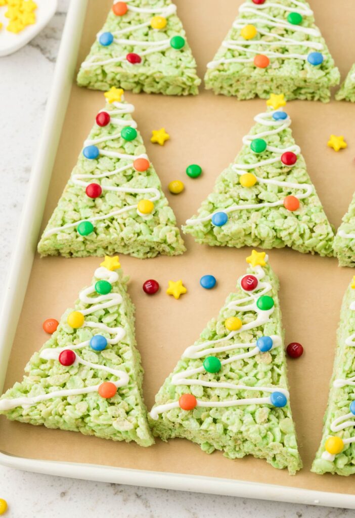 A baking sheet of christmas trees made from rice krispie treats