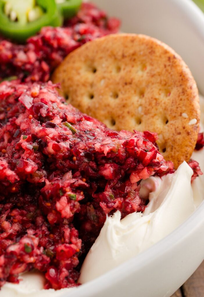 Side view of the cream cheese dip with a cracker