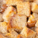 Close up of the bread pudding cubes soaked in eggnog sauce.