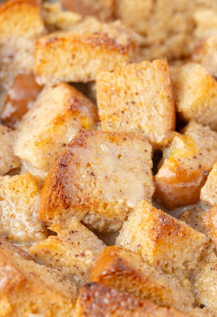 Close up of the bread pudding cubes soaked in eggnog sauce. 