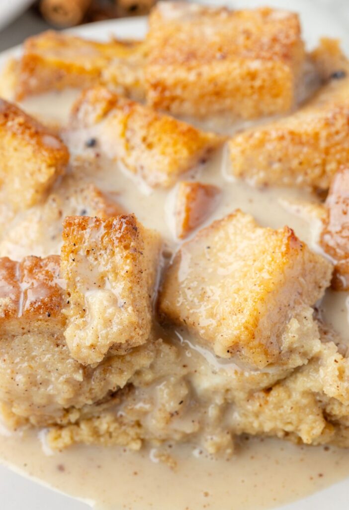 A serving of bread pudding with the eggnog glaze over top. 