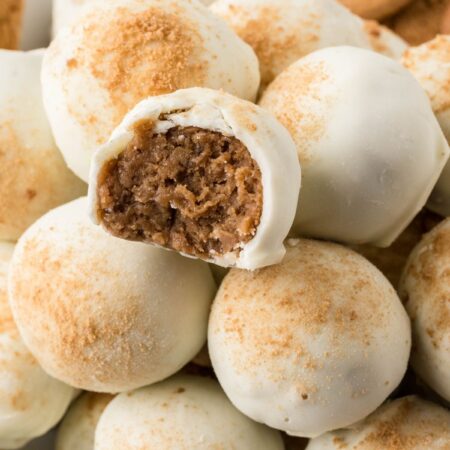 Plate of stacked truffles with the top with a bite taken out of it to show the center.