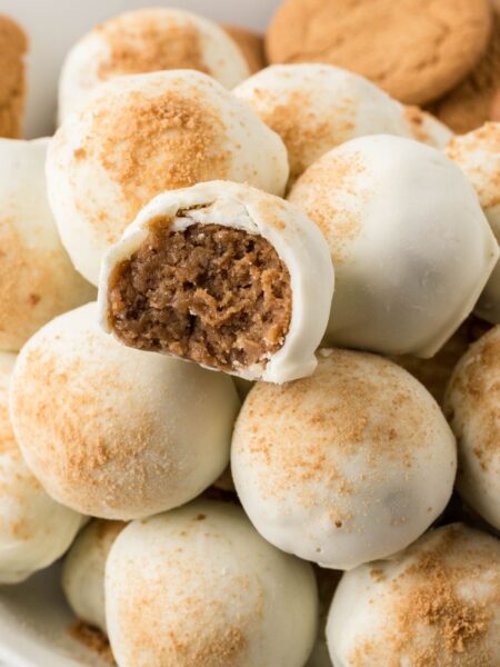 Plate of stacked truffles with the top with a bite taken out of it to show the center.