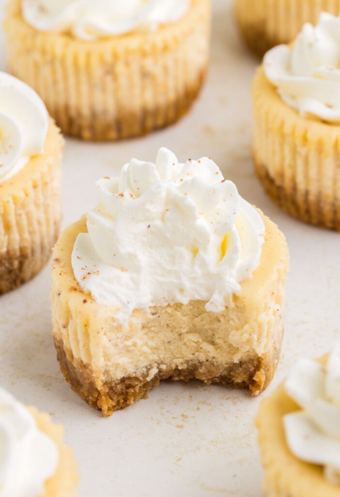 Mini cheesecakes with a bite taken out of the front cheesecake.