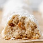 One cookie cut in half sitting on a wire cooling rack