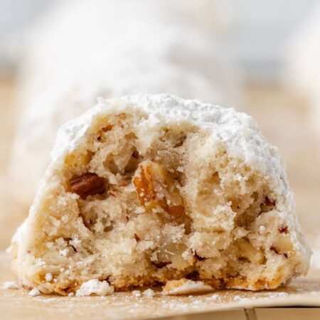 One cookie cut in half sitting on a wire cooling rack