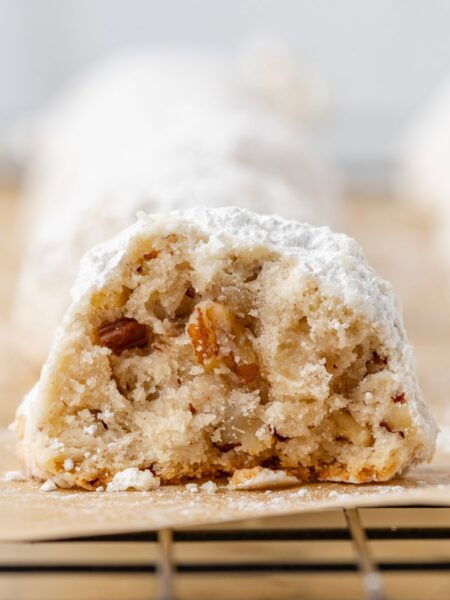 One cookie cut in half sitting on a wire cooling rack