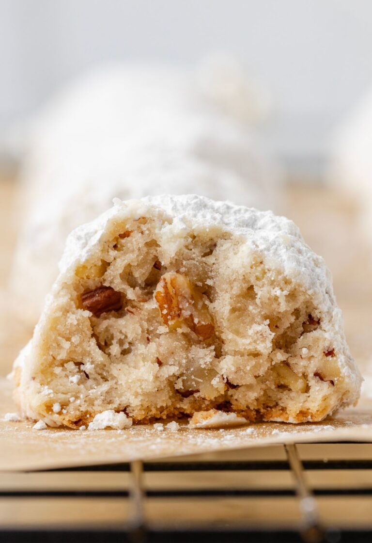 One cookie cut in half sitting on a wire cooling rack